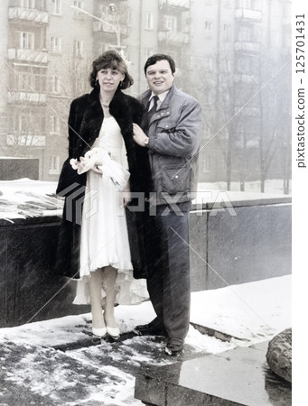 Vintage portrait of the bride and groom in the snowfall in the city. Retro photo 1993. Vintage portrait of the bride and groom in the snowfall in the city. Retro photo 1993. 125701431