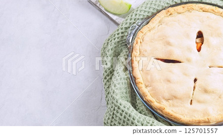 Sweet potato and apple cobbler in glass baking dish, horizontal top view copy space 125701557