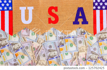 US dollars banknotes frame bold letters spelling USA, creating striking image of American prosperity identity. 125702425