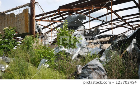 View to destroyed residential buildings at Kharkivska oblast. Ruined houses after bomb attacks on ukrainian territory from russia army. Consequences of russian invasion of Ukraine. Slow motion 125702454