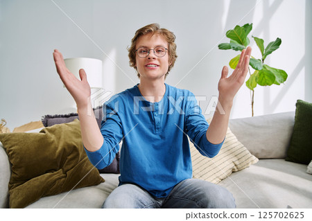 Webcam portrait male student teenager with glasses, sitting at home Webcam portrait male student teenager with glasses, sitting at home 125702625