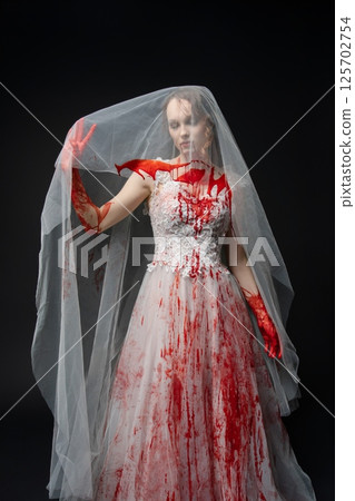 Bridal beauty transformed into a striking figure with blood and a katana Bridal beauty transformed into a striking figure with blood and a katana 125702754