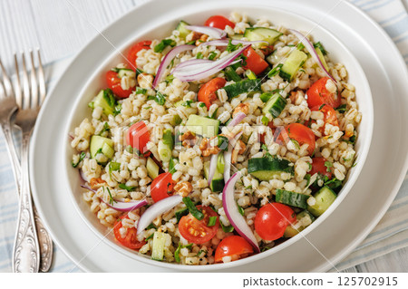 Barley salad with vegetables and walnuts in a bowl Barley salad with vegetables and walnuts in a bowl 125702915