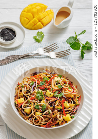 Thai Mango Noodle Veggie Salad in a bowl Thai Mango Noodle Veggie Salad in a bowl 125702920