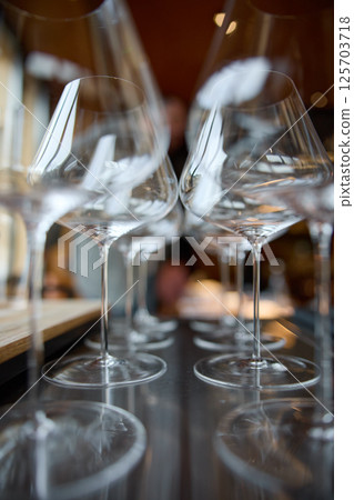 Clean wine glasses are on the table of a special wine cabinet, stylish table setting, ice, bottle of sparkling wine, light from window, decoder and degasser Clean wine glasses are on the table of a special wine cabinet, stylish table setting, ice, bottle of sparkling wine, light from window, decoder and degasser 125703718