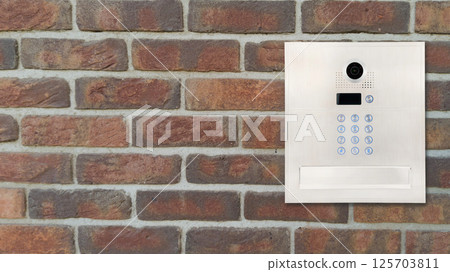 Modern Intercom Panel on Brick Wall Modern Intercom Panel on Brick Wall 125703811