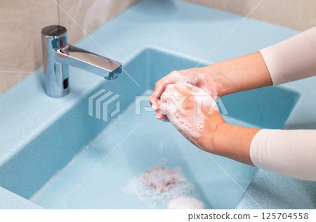 Hand washing with soap and water at sink Hand washing with soap and water at sink 125704558