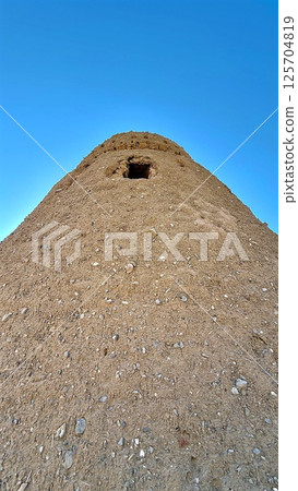 Ras Al Khaimah, UAE - March 29, 2025:Stone fortress anchors dry hillside, framed by endless azure sky, ancient architecture exudes timeless dignity and invites discovery, landmark ,tourist attraction. Ras Al Khaimah, UAE - March 29, 2025:Stone fortress anchors dry hillside, framed by endless azure sky, ancient architecture exudes timeless dignity and invites discovery, landmark ,tourist attraction. 125704819