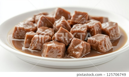 Gourmet Wet Cat Food with Tender Chunks in Rich Gravy on White Plate Gourmet Wet Cat Food with Tender Chunks in Rich Gravy on White Plate 125706749