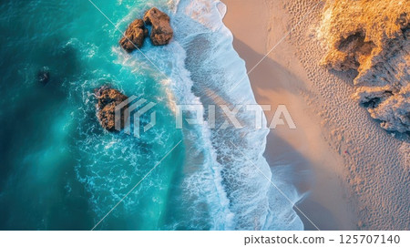 Ocean Waves Crashing Gently on the Sandy Shore with Coastal Rocks, Tranquil Seascape View 125707140