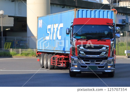 A trailer truck turning right at an intersection 125707354