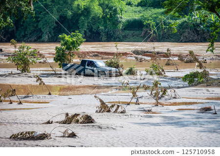 Truck stuck in mud after flooding by Kok river in Chiang Rai province of Thailand. Truck stuck in mud after flooding by Kok river in Chiang Rai province of Thailand. 125710958