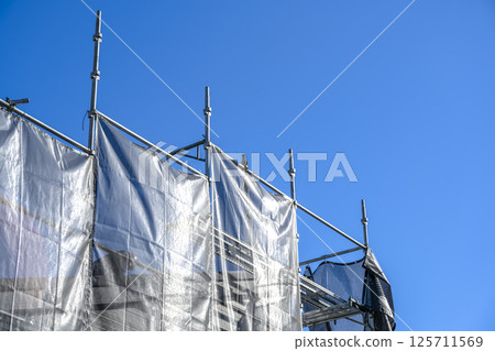 Roof repair work on a detached house Roof worker 125711569