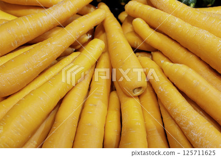 Many carrots neatly displayed 125711625