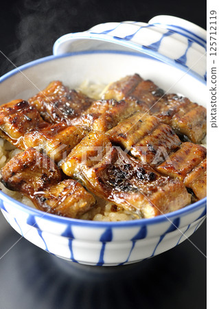 Hot unadon photographed against a black background Hot unadon photographed against a black background 125712119