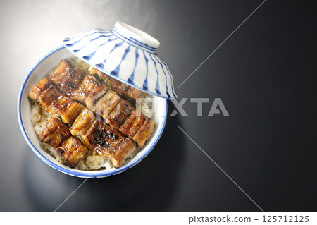 Hot unadon photographed against a black background 125712125