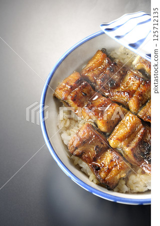 Hot unadon photographed against a black background 125712135