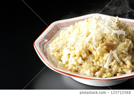 Hot fried rice photographed alone against a black background Hot fried rice photographed alone against a black background 125712568