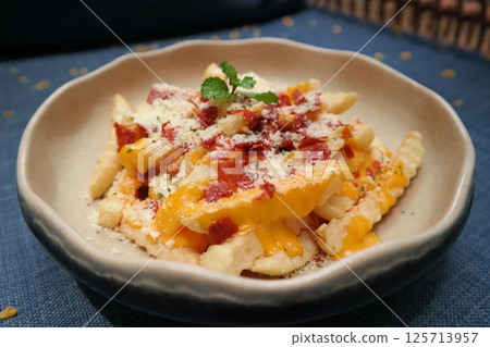 fresh cheesy fries in dish in restaurant 125713957