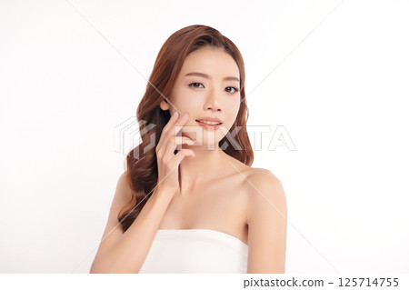 A beautiful young Asian woman with clean, fresh skin against a white background. Skincare, facial treatment, cosmetology, beauty, and spa. An elegant portrait of an Asian woman. A beautiful young Asian woman with clean, fresh skin against a white background. Skincare, facial treatment, cosmetology, beauty, and spa. An elegant portrait of an Asian woman. 125714755