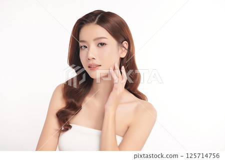 A beautiful young Asian woman with clean, fresh skin against a white background. Skincare, facial treatment, cosmetology, beauty, and spa. An elegant portrait of an Asian woman. A beautiful young Asian woman with clean, fresh skin against a white background. Skincare, facial treatment, cosmetology, beauty, and spa. An elegant portrait of an Asian woman. 125714756