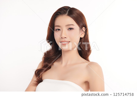 A beautiful young Asian woman with clean, fresh skin against a white background. Skincare, facial treatment, cosmetology, beauty, and spa. An elegant portrait of an Asian woman. 125714758