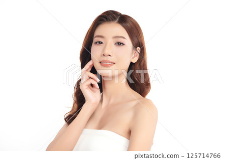 A beautiful young Asian woman with clean, fresh skin against a white background. Skincare, facial treatment, cosmetology, beauty, and spa. An elegant portrait of an Asian woman. 125714766