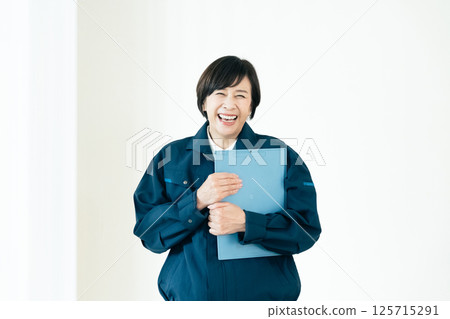 Senior woman in work clothes Senior woman in work clothes 125715291