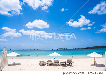 (Image of a beach resort) Blue sea and white sand (Image of a beach resort) Blue sea and white sand 125715361