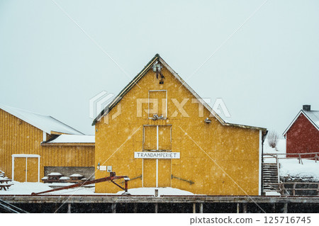 A colorful village by Snowy Fjord in Winter. Nusfjord, Lofoten. 125716745