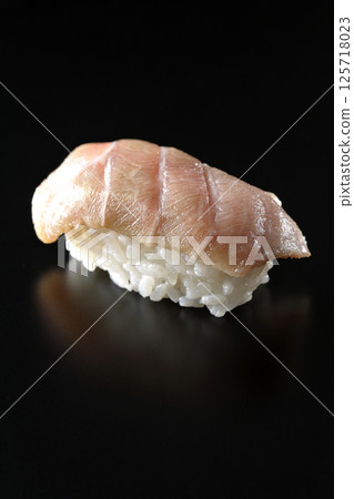 Fatty tuna nigiri photographed against a black background 125718023
