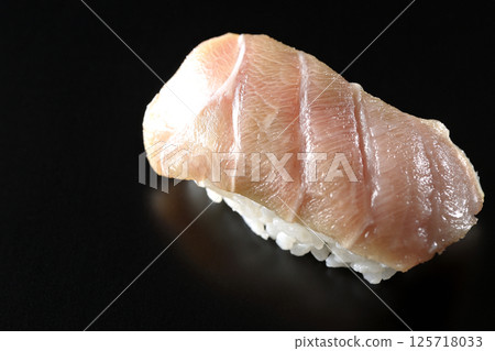 Fatty tuna nigiri photographed against a black background Fatty tuna nigiri photographed against a black background 125718033