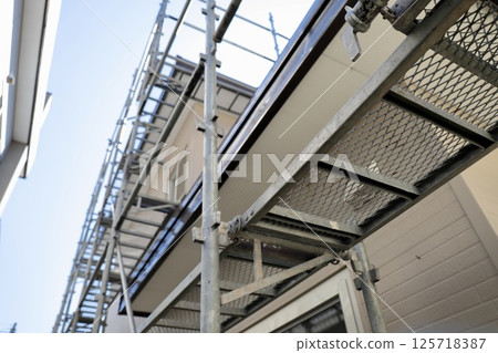 Repair work site of an old detached house with wedge scaffolding Repair work site of an old detached house with wedge scaffolding 125718387