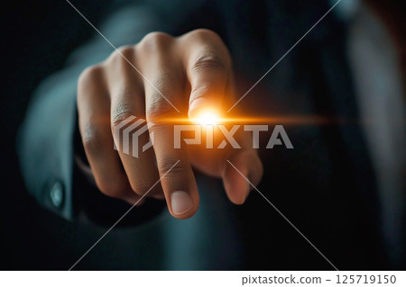Human hand touching a glowing digital button surrounded by abstract circles, symbolizing the concept of power, unlocking, or switching systems on or off Human hand touching a glowing digital button surrounded by abstract circles, symbolizing the concept of power, unlocking, or switching systems on or off 125719150
