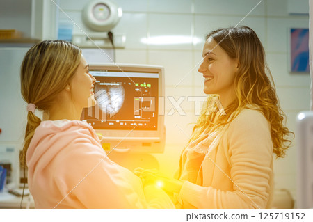 Surrogate mother during a routine medical check-up at a sunny fertility clinic. The scene conveys warmth, care, and professionalism, highlighting aspects of pregnancy, maternity health Surrogate mother during a routine medical check-up at a sunny fertility clinic. The scene conveys warmth, care, and professionalism, highlighting aspects of pregnancy, maternity health 125719152