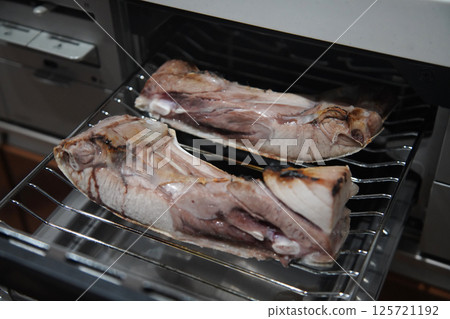 Grilling tuna loins on a fish grill 125721192