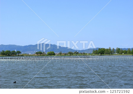 Spring blue sky and the mountain range separating Shiga and Kyoto prefectures and Lake Taira Spring blue sky and the mountain range separating Shiga and Kyoto prefectures and Lake Taira 125721592