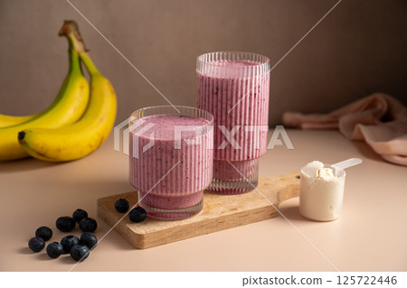 Banana blueberry protein smoothie in a glass. 125722446