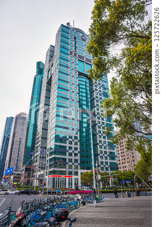 Shanghai, China - Modern business district in Pudong featuring Yestar plastic surgery clinic in a striking turquoise-glass skyscraper with "M" logo at Metrobank Plaza Shanghai, China - Modern business district in Pudong featuring Yestar plastic surgery clinic in a striking turquoise-glass skyscraper with "M" logo at Metrobank Plaza 125722626