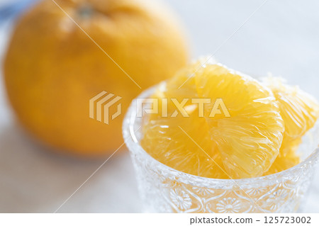 Sweet summer oranges served in a glass bowl Sweet summer oranges served in a glass bowl 125723002