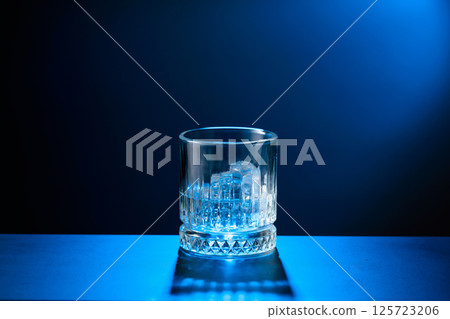 Vodka with ice on a black table. 125723206