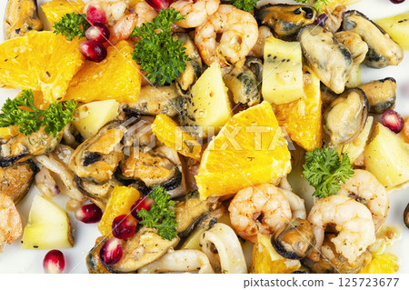 Plate of delicious fruit salad with seafood. 125723677