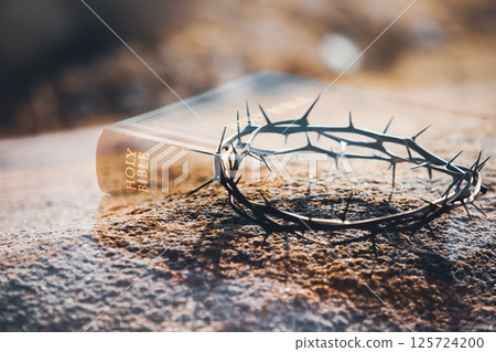 A crown of thorns and a Bible symbolizing the sacrifice and suffering of Jesus Christ on the cross, with a background of Holy Week 125724200