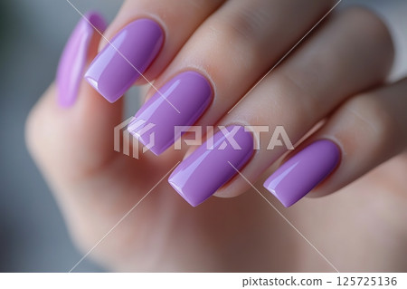 Beautiful woman's hands with purple nail manicure 125725136