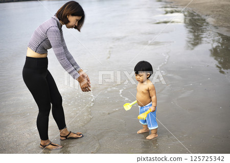 Mother And Child Having Fun At The Beach, Background for advertising and wallpaper in relaxion and lifestyle scene. Mother And Child Having Fun At The Beach, Background for advertising and wallpaper in relaxion and lifestyle scene. 125725342
