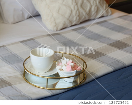 A Cozy Bed Scene Decorated with Tea and Sweets, All Beautifully Arranged on a Tray 125725431