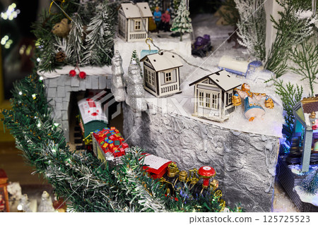 A stunning Christmas Village scene with a charming railway and snowcovered houses 125725523