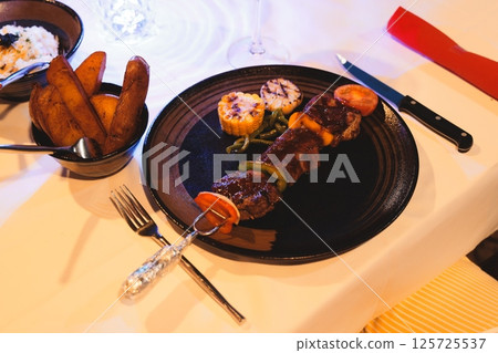 Indulge in these Delicious Grilled Skewers accompanied by Sides in an Elegant Setting Indulge in these Delicious Grilled Skewers accompanied by Sides in an Elegant Setting 125725537