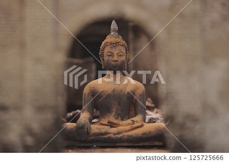 A Serene Buddha Statue Framed Beautifully Within Stunning Ancient Architecture Structures A Serene Buddha Statue Framed Beautifully Within Stunning Ancient Architecture Structures 125725666