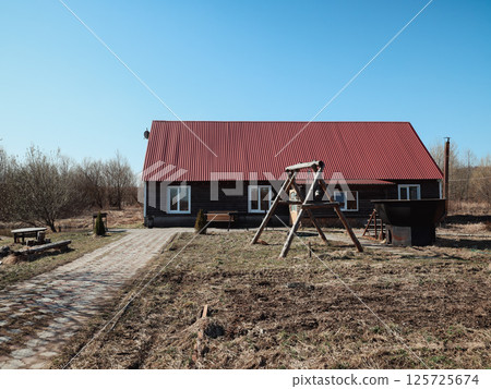 Charming Countryside House Featuring a Swing in a Beautiful, Serene Landscape Setting Charming Countryside House Featuring a Swing in a Beautiful, Serene Landscape Setting 125725674